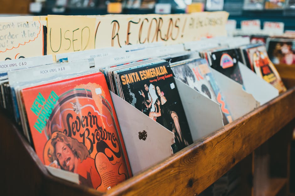 Close-up of vintage vinyl records in a music store display, emphasizing classic album covers.