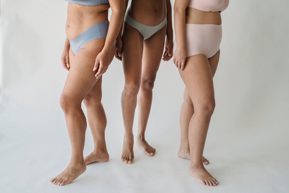 A group of diverse women standing barefoot in stylish underwear, promoting body positivity.