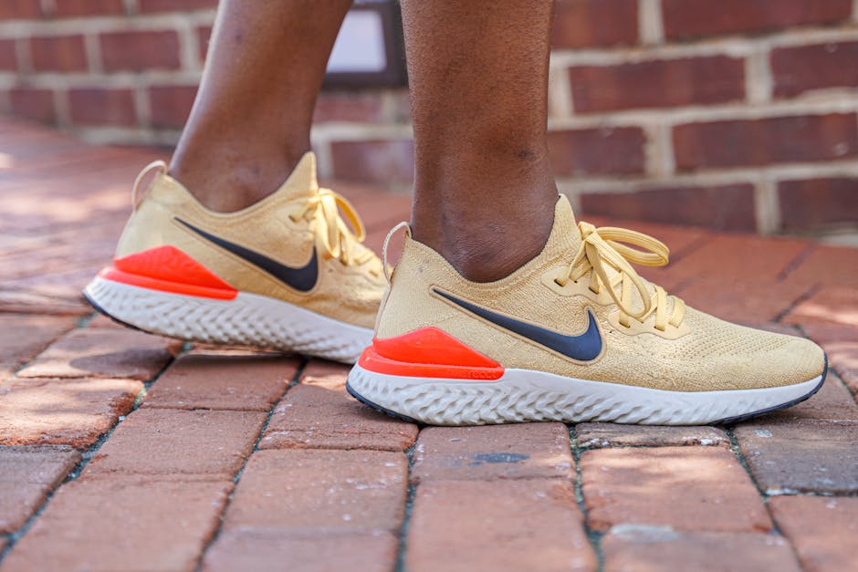 Close-up of Nike sneakers with vibrant design on a brick street, perfect for urban fashion inspiration.