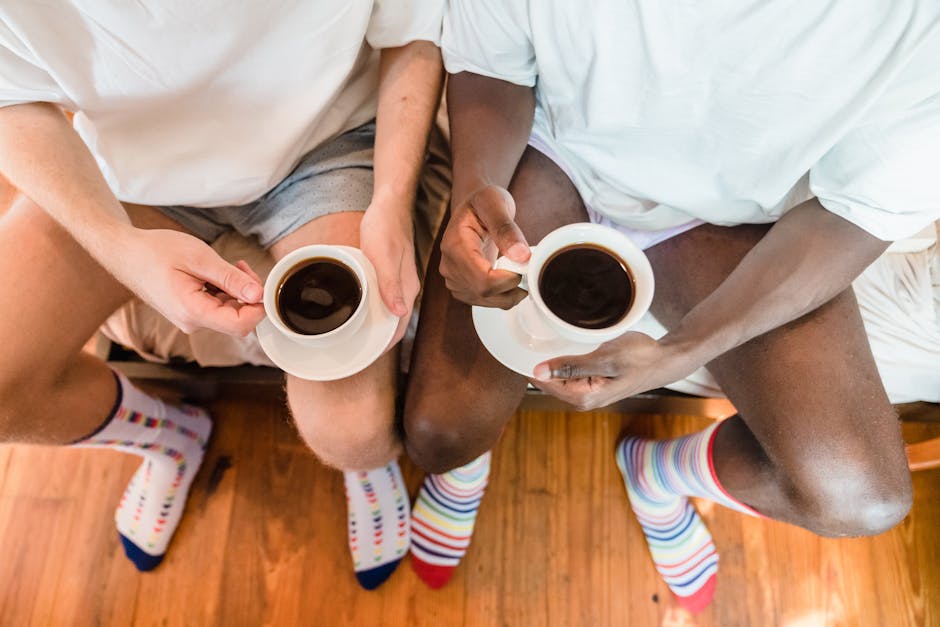A close-up of two individuals enjoying coffee, wearing colorful socks, captured from above.