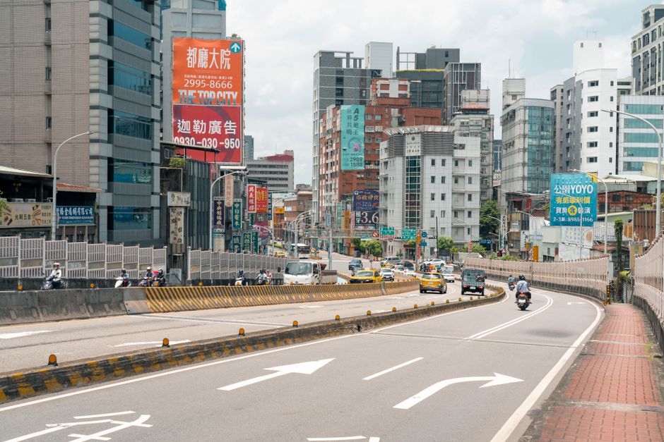 A bustling street scene in Taipei, Taiwan, featuring modern architecture and city life.