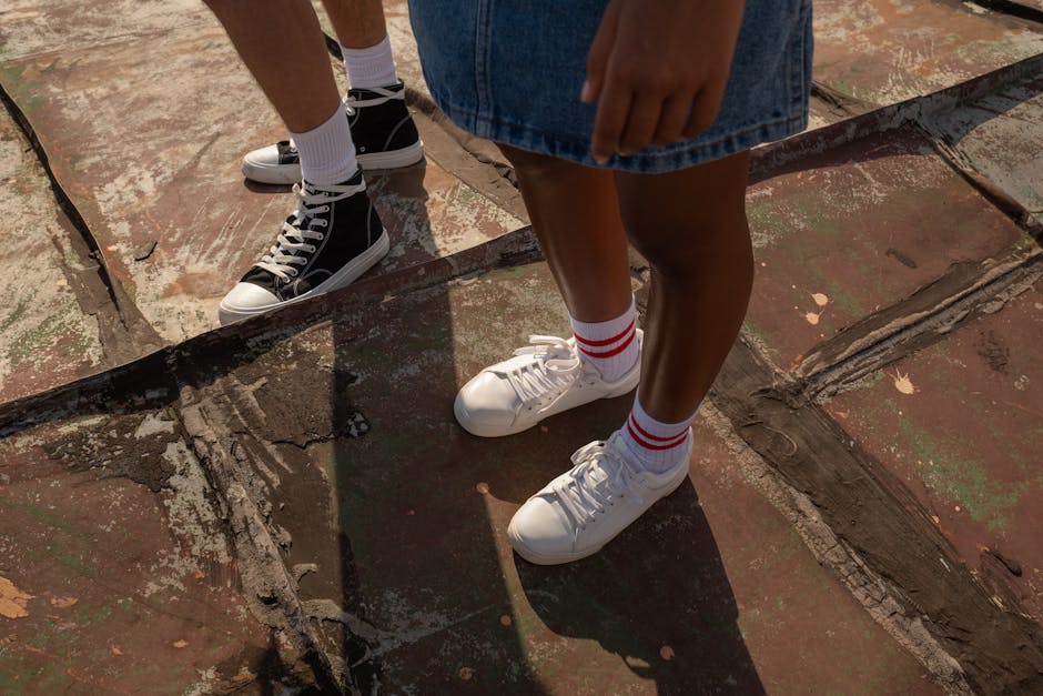 Close-up of teenagers standing on a rooftop, showcasing casual style with sneakers.