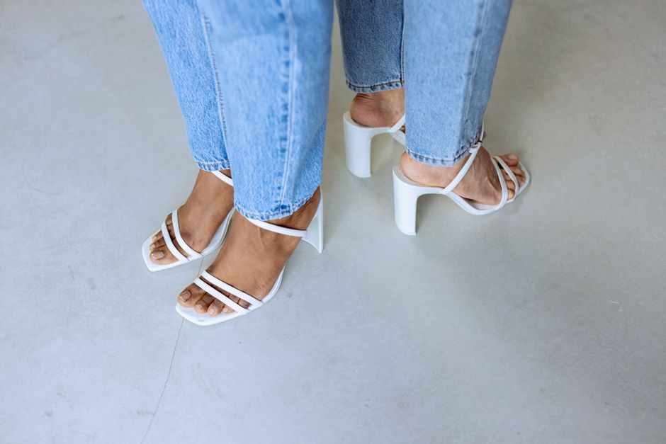 White strappy block-heel sandals worn with cropped jeans